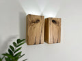 Modern rustic oak wood wall lights casting up and down light