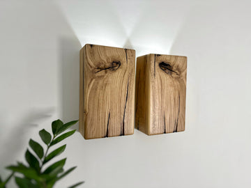 Modern rustic oak wood wall lights casting up and down light