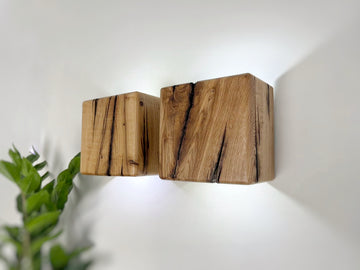 Modern rustic oak wood wall lights casting up and down light