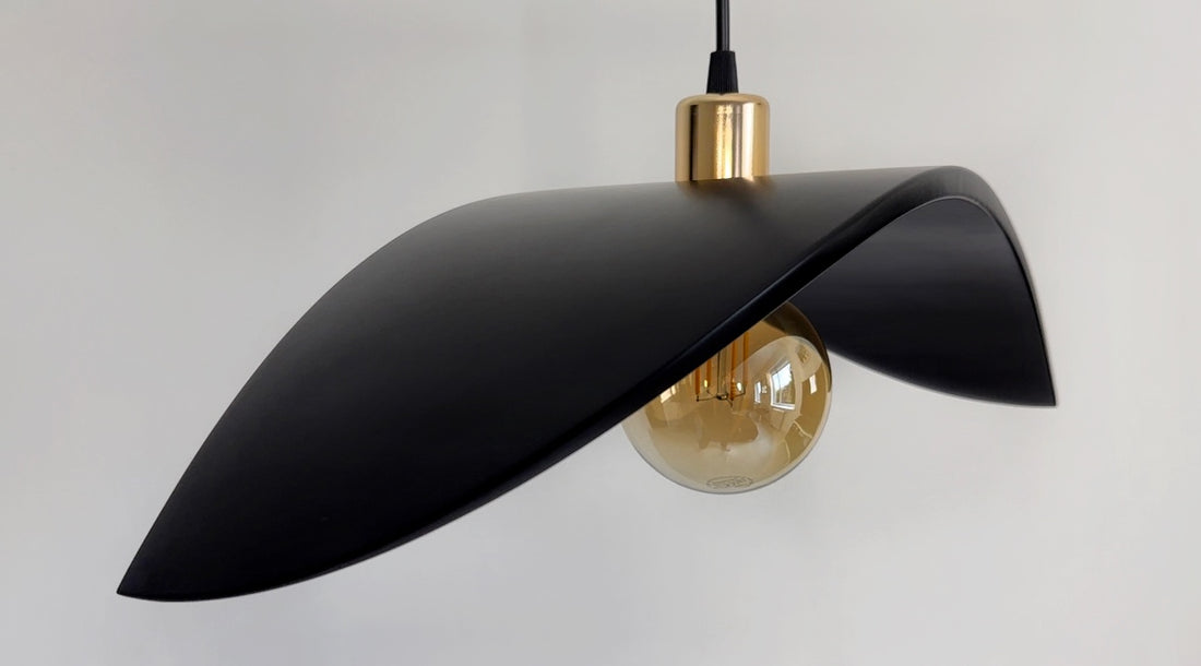 Modern matte black sculptural pendant light with gold accents
