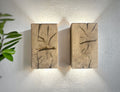 Modern rustic oak wood wall lights casting up and down light