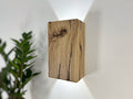 Modern rustic oak wood wall lights casting up and down light
