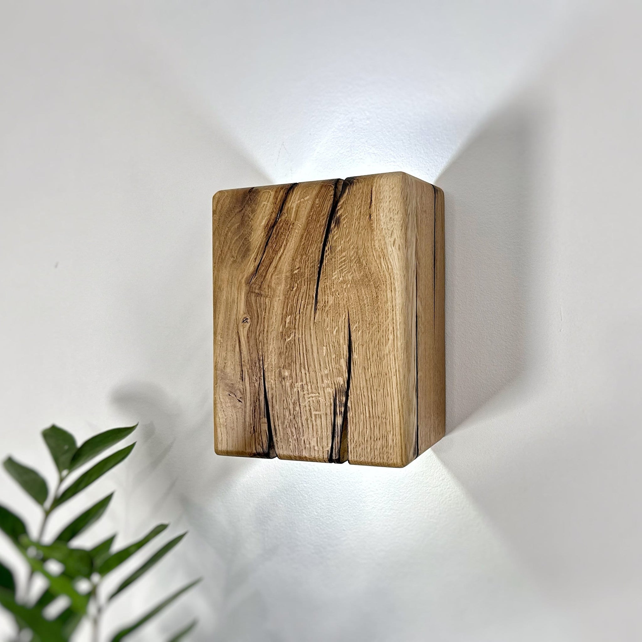 Rustic oak up-down wall sconce highlighting natural wood features