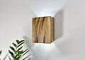 Rustic oak up-down wall sconce highlighting natural wood features