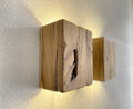 Modern rustic oak wood wall lights casting up and down light