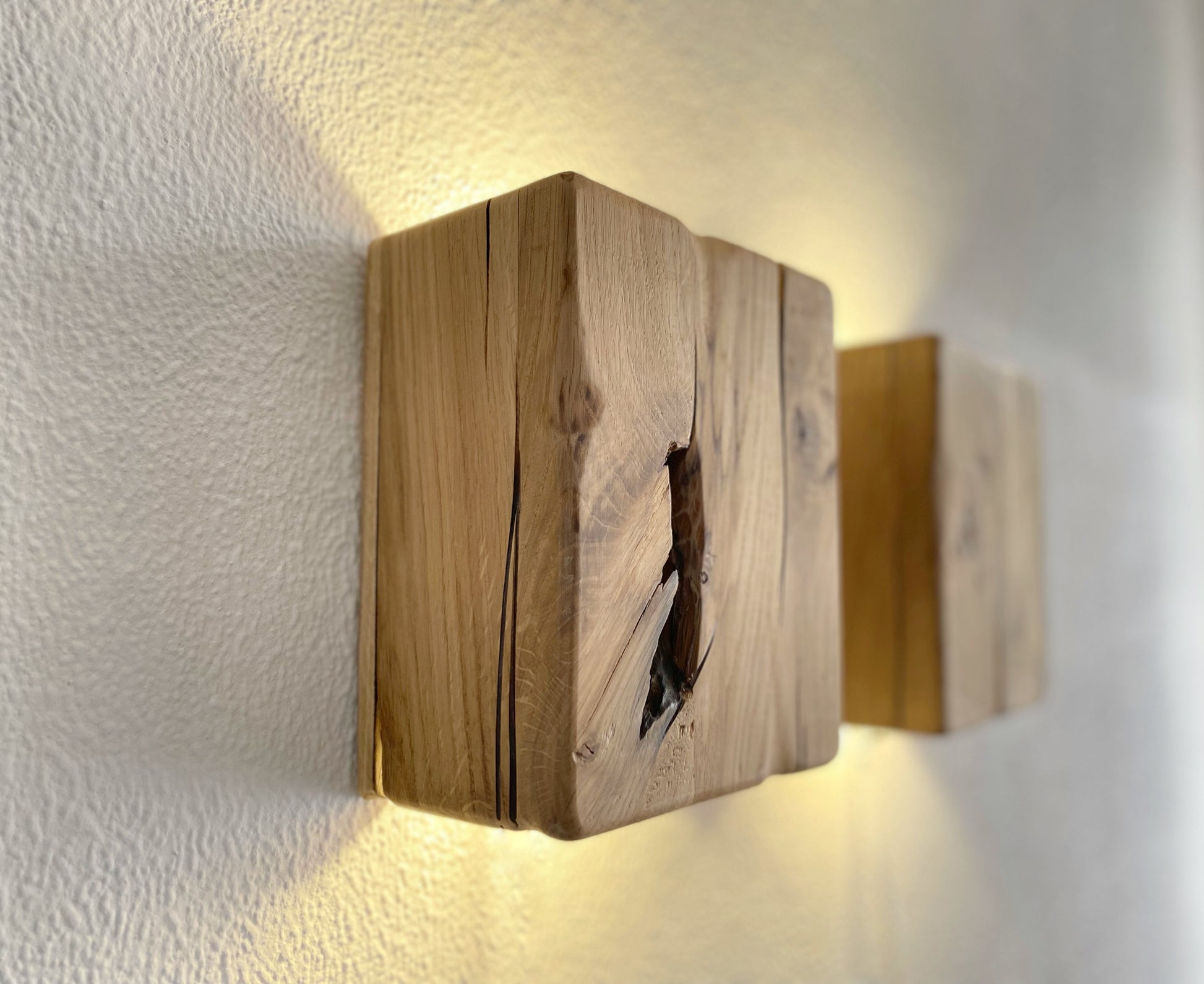 Modern rustic oak wood wall lights casting up and down light