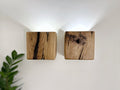 Modern rustic oak wood wall lights casting up and down light