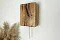 Wooden wall sconce with pull chain 
with natural finish on a white wall
